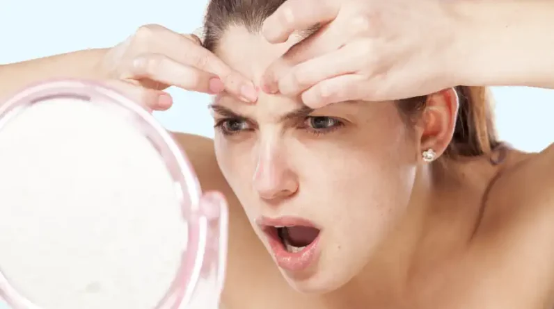 Girl Popping a Pimple